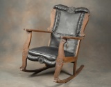 Ornate antique oak Rocker in original estate condition with fancy early leather upholstery, circa 19