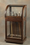 Antique curved glass wooden Cane Cabinet, circa 1900s, holds up to 48 Canes, 48