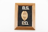Gold Shield Badge with raised porcelain letters marked 