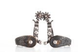 Outstanding pair of single mounted hand engraved silver overlay Spurs with Cheyenne, Wyoming split h