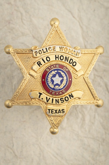 Gold tone 6-point Ball Star Badge, marked â€œPOLICE WOMAN /RIO HONDO, TEXASâ€ / T. Vinson", measure