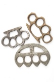 Three sets of metal Knuckles: One appears to be cast Brass, one Steel, and one large Steel. Will be