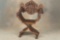 One of a near matching pair of heavily carved antique Fire Side Chairs, circa 1880s-90s, with massiv
