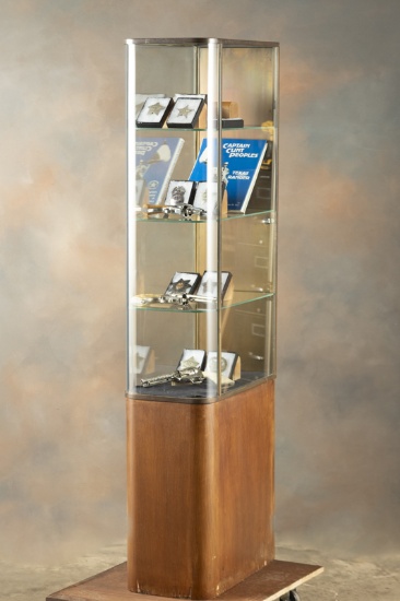 Unique vintage curved glass, floor model Showcase with wooden base and metal trim, two rear door ent
