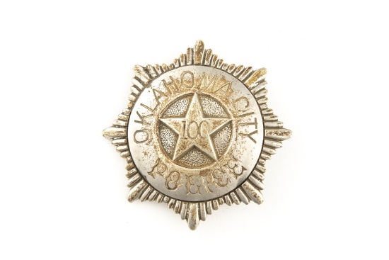 Sunburst shaped vintage Badge marked â€œOKLAHOMA CITY POLICEâ€ with â€œ100â€ in raised star center