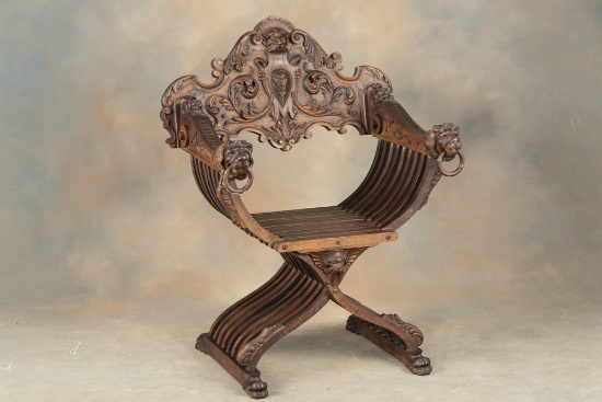 One of a near matching pair of heavily carved antique Fire Side Chairs, circa 1880s-90s, with massiv