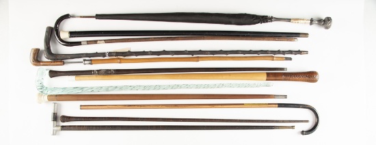 Collection of 12 Walking Sticks, Canes and one Umbrella in various shapes and sizes. One of these is