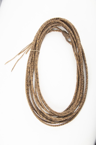 Vintage braided rawhide Reata, approximately 40 ft. long with rawhide and braided hondo. Very good c