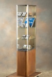 Unique vintage curved glass, floor model Showcase with wooden base and metal trim, two rear door ent