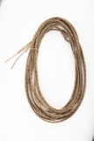 Vintage braided rawhide Reata, approximately 40 ft. long with rawhide and braided hondo. Very good c