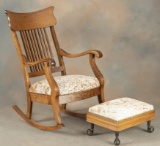 One of a matched pair of antique oak, arrow back Arm Rockers with matching glass ball and brass claw