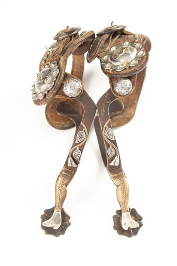 Unique pair of single mounted gal-leg Spurs with engraved leaves and vines on heel bands. Spurs are