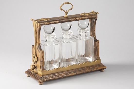 Unique wooden and brass Tantalus (Portable Liquor Case) with three matching crystal decanters with g