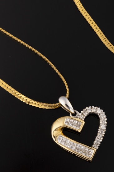 Ladies 14kt yellow gold 1.60ctw baguette diamond heart with 14kt white gold "70". Weighing 8.5 grams