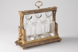 Unique wooden and brass Tantalus (Portable Liquor Case) with three matching crystal decanters with g