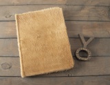 This lot consists of the following  two items to include: A hair on hide Book #130 titled 