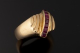Ladies 14kt yellow gold dome ring containing six 3x3 mm princess cut rubies. Ring weighs 12.8 grams.