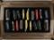 Assorted pocketknives in wooden display