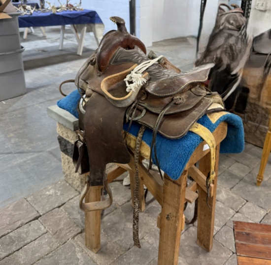 Saddle with stand, stirrups, reins, misc leather