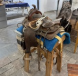 Saddle with stand, stirrups, reins, misc leather