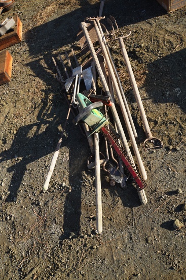 PILE OF RAKES, WRENCHES, TRIMMER, ETC.