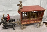 Circus trailer with man and 2 Cast Iron horses, one with rider, cast iron lion, Approx. 14”