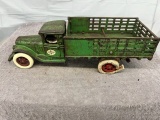 Arcade International stake delivery truck with man, tires are weathered, Approx. 12”