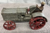 Cast Iron McCormick-Deering tractor with man, approx. 7”