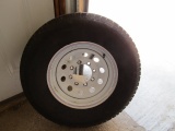 370. USED 235/80R/16 TIRE ON 8 BOLT TRAILER RIM, TAX