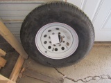 371. USED ST 235/80R/16 TIRE ON 8 BOLT TRAILER RIM, TAX