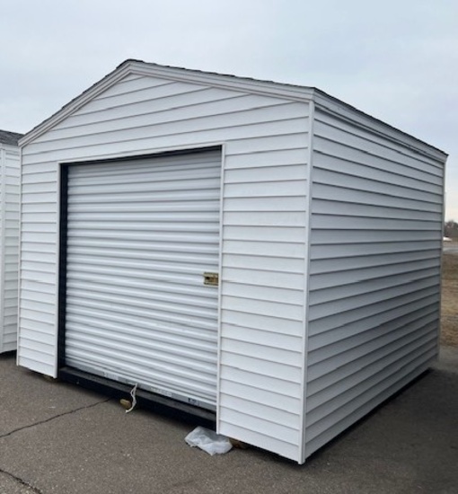 1972. 10’ x 12 Storage Sheds with 6’ Rollup Door, White in Color