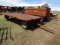 1310. 9 X 16 FT. METAL FLAT RACK ON MN 7 TON FOUR WHEEL WAGON