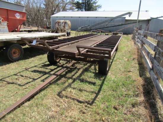 1301. 8.5 FT. X 22 FT. STEEL BALE RACK WITH BALE STOPS ON 4 WHEEL WAGON