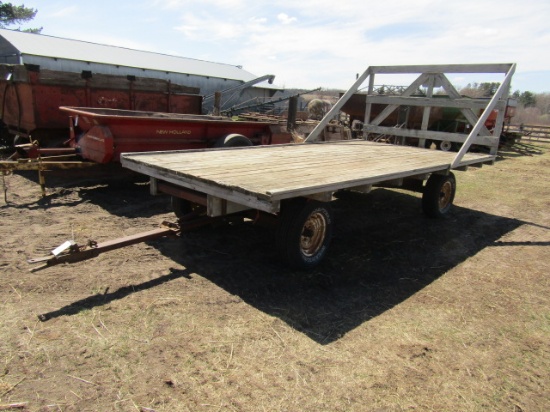1307. NICE 8 FT. X 16 FT. WOODEN FLAT RACK ON HARMS FOUR WHEEL WAGON, SPRIN