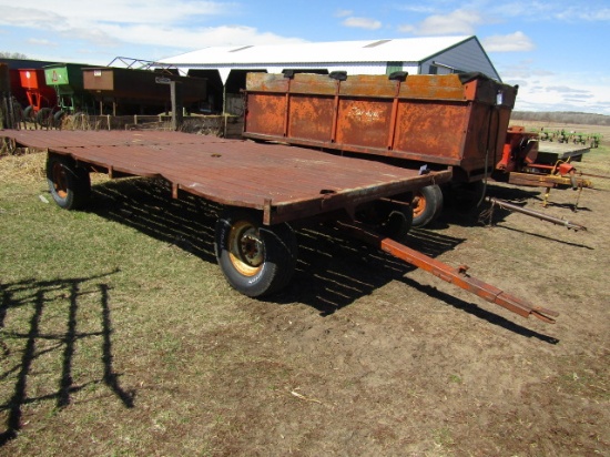 1310. 9 X 16 FT. METAL FLAT RACK ON MN 7 TON FOUR WHEEL WAGON
