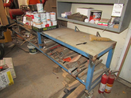 1509. METAL 20” X 12’ WORK BENCH ON ROLLERS WITH MISC. IRON ON SHELF