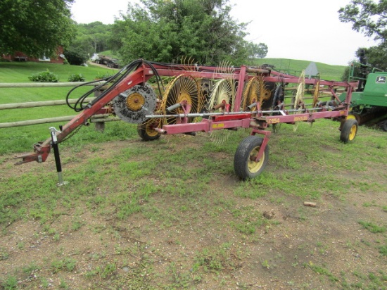 1669. NEW HOLLAND MODEL HT154 12 WHEEL V RAKE ON HYDRAULIC CART,