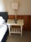 White bedside table with lamp