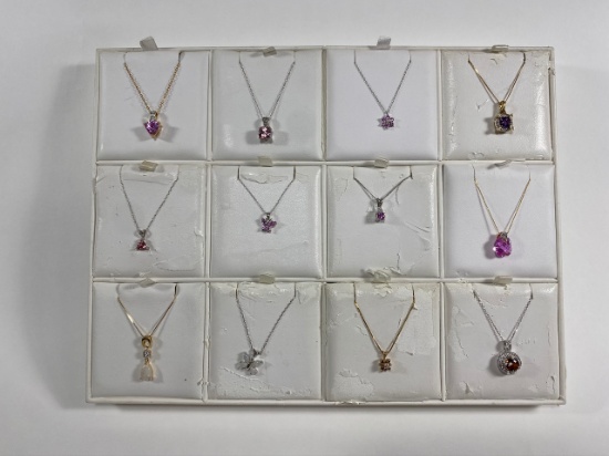 Necklaces on various chains, some gold. Estimated Lot Value of $2,525.00 for all 12 necklaces.