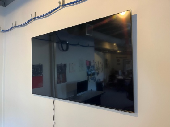 Loc: 12.2. Samsung 65" Flat screen TV with wall mount. This lot is located at: 200 Michigan St, Hanc