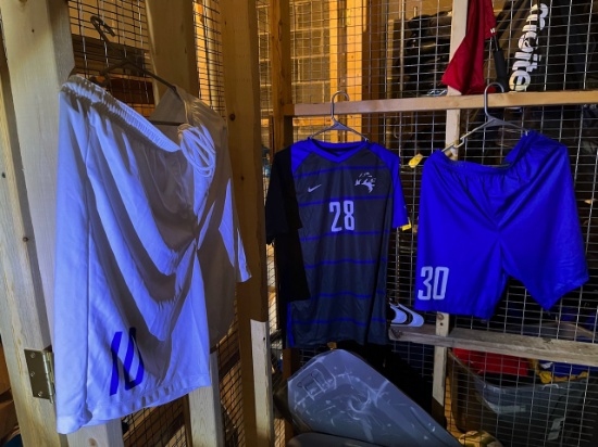 Loc: 2, 105. Soccer Shorts, white and blue & jerseys of assorted numbers and sizes. This lot is loca