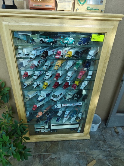 57 Unique and Antique Model Replica Trucks in a Display Case