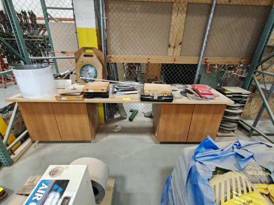Work bench with cabinets and large amount of misc saw blades
