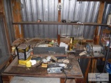 Contents of tool shelf in corner of outbuilding - including power tools