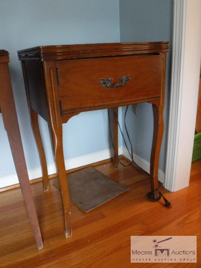 Sewing machine in wooden cabinet