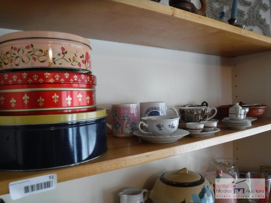 Large shelf lot of tea cups and tins