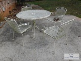 Wrought iron table with four chairs and umbrella