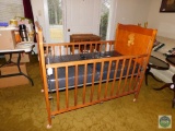 Vintage wooden baby crib with mattress