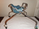 Metal child's walker with cloth seat