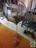 Metal bird cage on metal stand